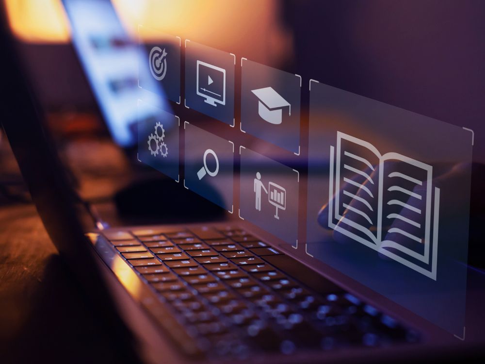 A imagem representa o uso de ferramentas educacionais online que facilitam o acesso ao conhecimento e ampliam a experiência de aprendizagem.